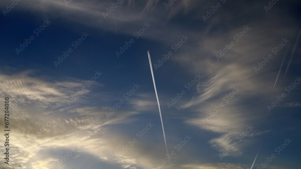 Blue sky with clouds and an airplane Blue sky with clouds and an airplane