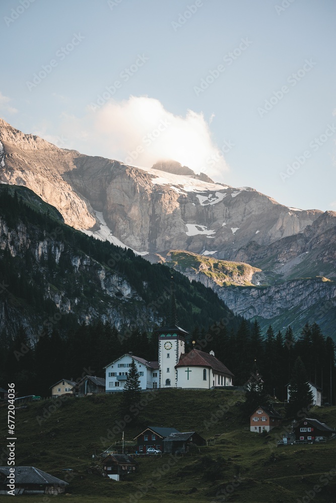 Beautiful vertical view of a church in Ticino village on a mountain background