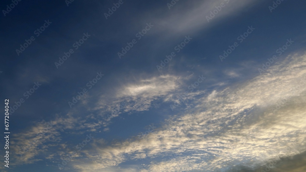 Blue sky with clouds and an airplane 