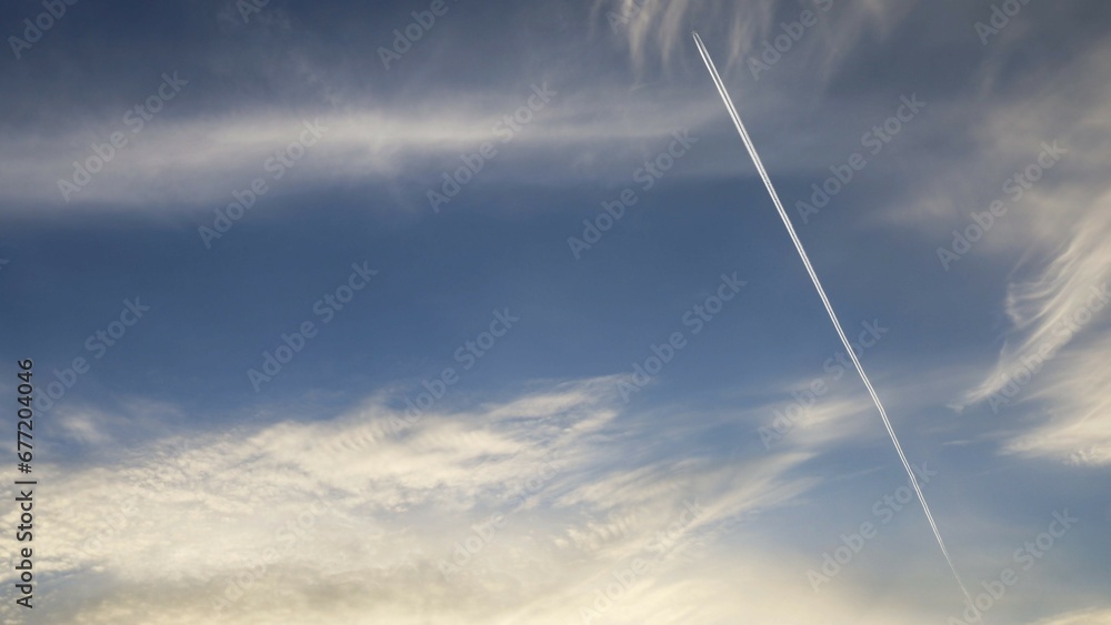 Blue sky with clouds and an airplane Blue sky with clouds and an airplane