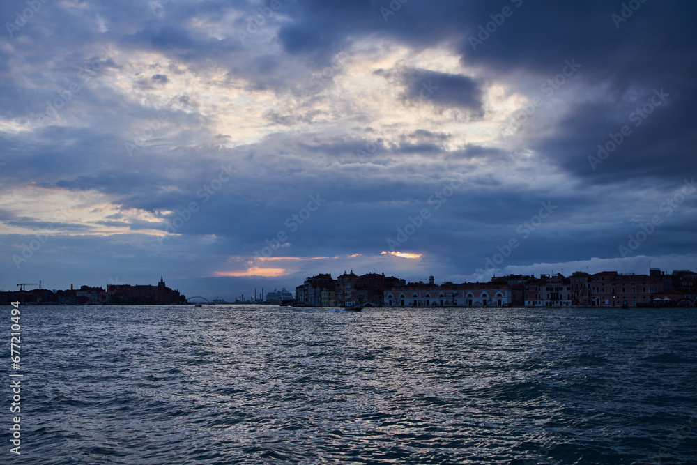 Dramatic cloudy sky above Guidecca canal in Venetian lagoon