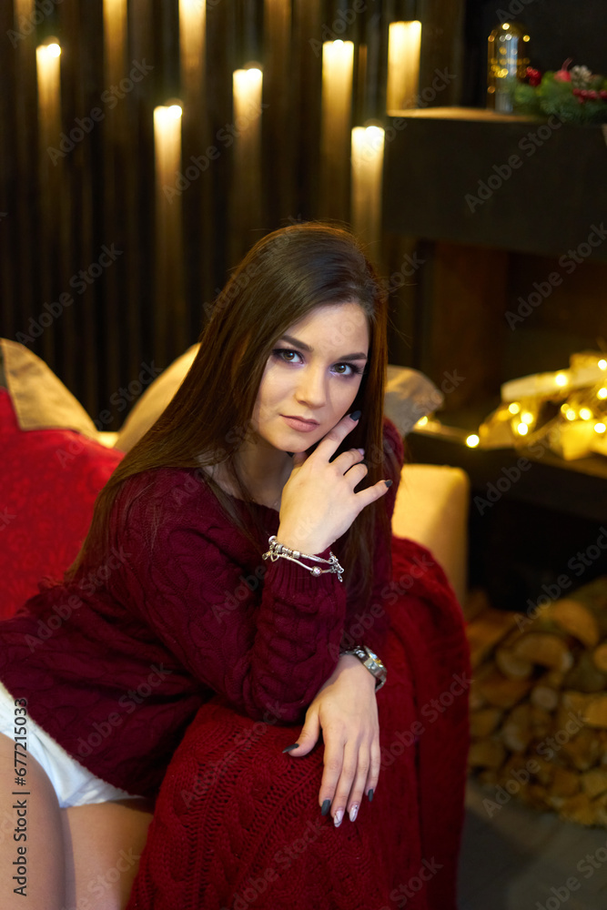 A joyful smiling young woman is preparing for the Christmas holiday A joyful smiling young woman is preparing for the Christmas holiday