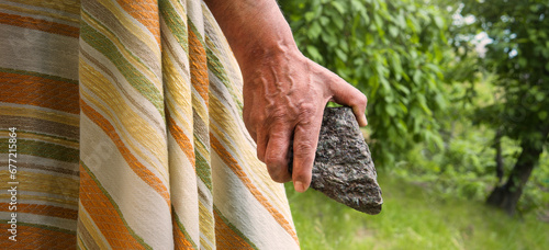 Male hand with big stone