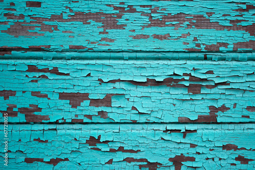 Old blue wooden wall with peeling paint. Abstract background for design.