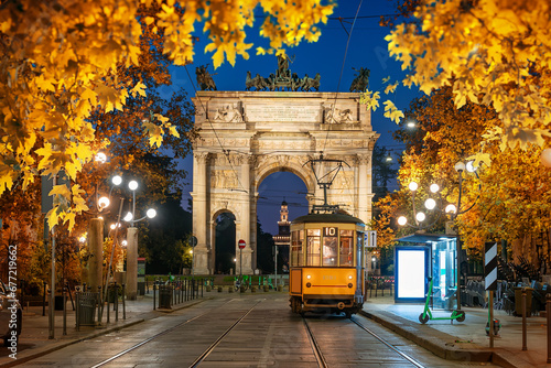 Arch and yellow tram in autumn photo