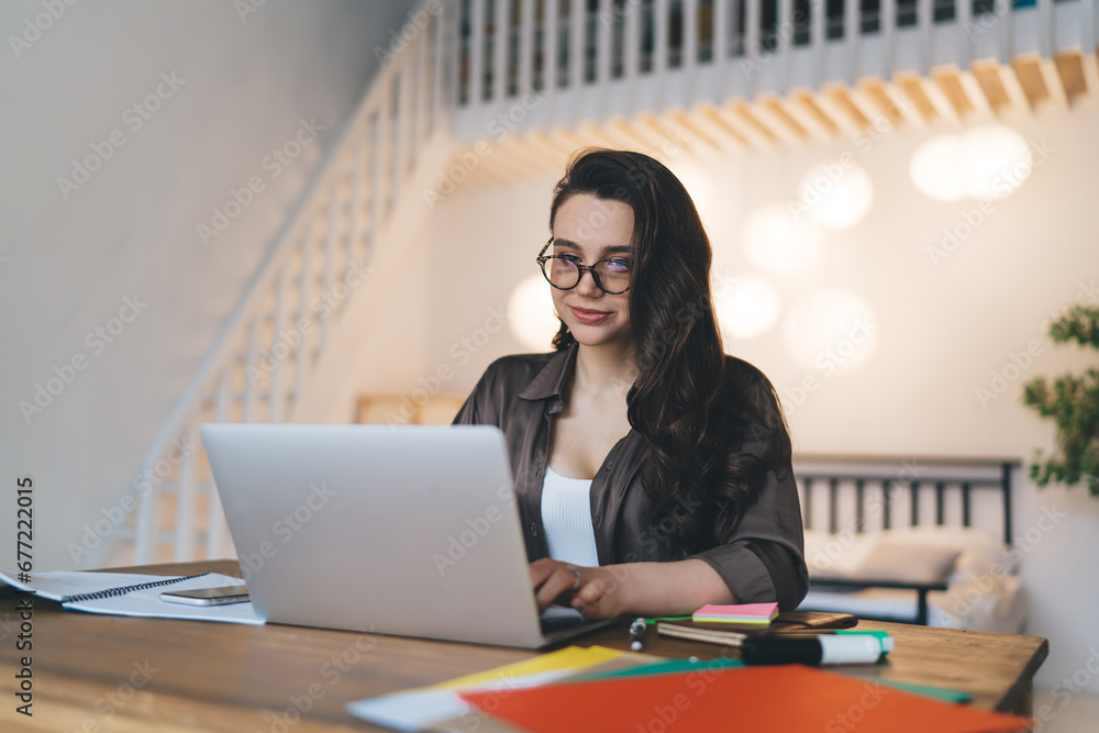 Focused female freelancer typing text on netbook working remotely from home Focused female freelancer typing text on netbook working remotely from home