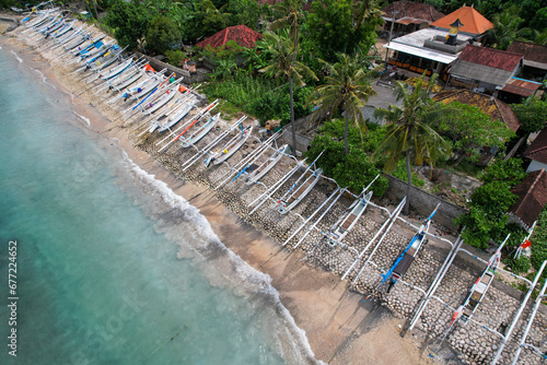 Aerial view of traditional Bali boats (Jukung) on the sea shore in Suana village. Nusa Penida Island, Indonesia. photo