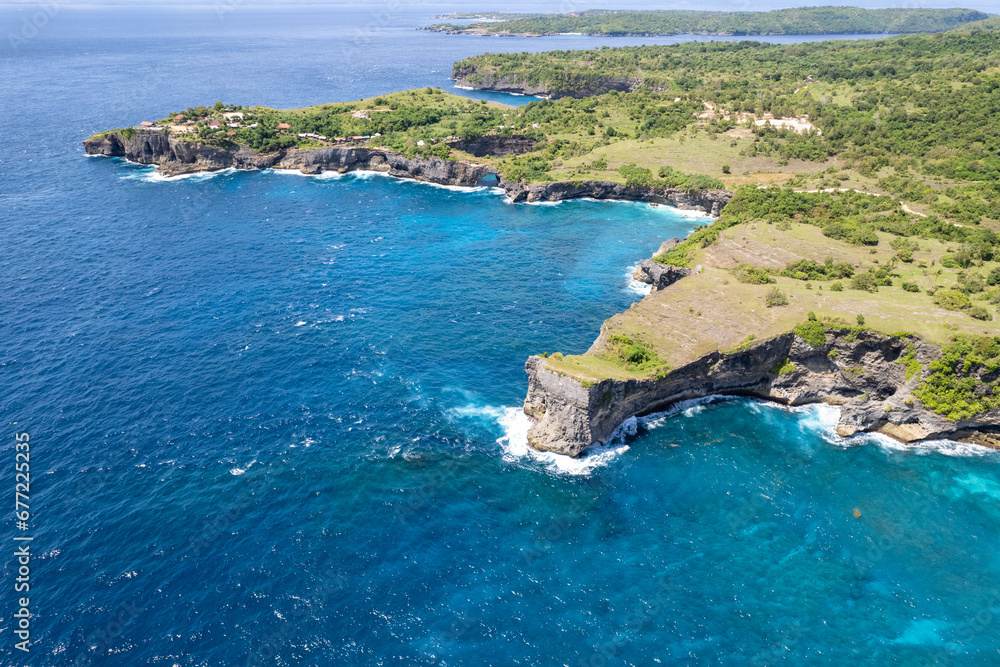 Aerial view of Dolphin Bay; Broken Beach and Angel's Billabong on sunny day. Nusa Penida Island, Indonesia.