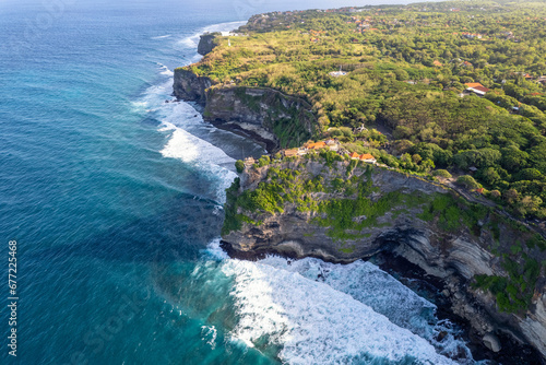 Aerial view of the cliff with Uluwatu hindu Temple on sunny day. Bali, Indonesia.