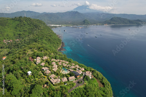 Aerial view of coastline nearby Blue Lagoon Beach and Mount Agung on sunny day. Padangbai, Bali, Indonesia.