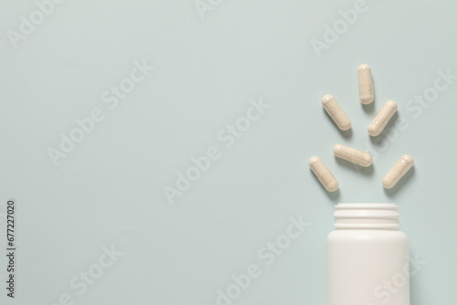 white plastic bottle and pills photo