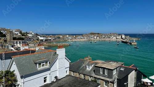 Aerial landscape of St Ives city coast with houses and blue sky on the horizon in England
