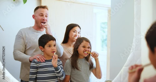 Happy family, brushing teeth and morning routine in mirror, reflection and bathroom for hygiene and wellness. Dental care, oral health and toothbrush with toothpaste, gum disease, cleaning mouth photo