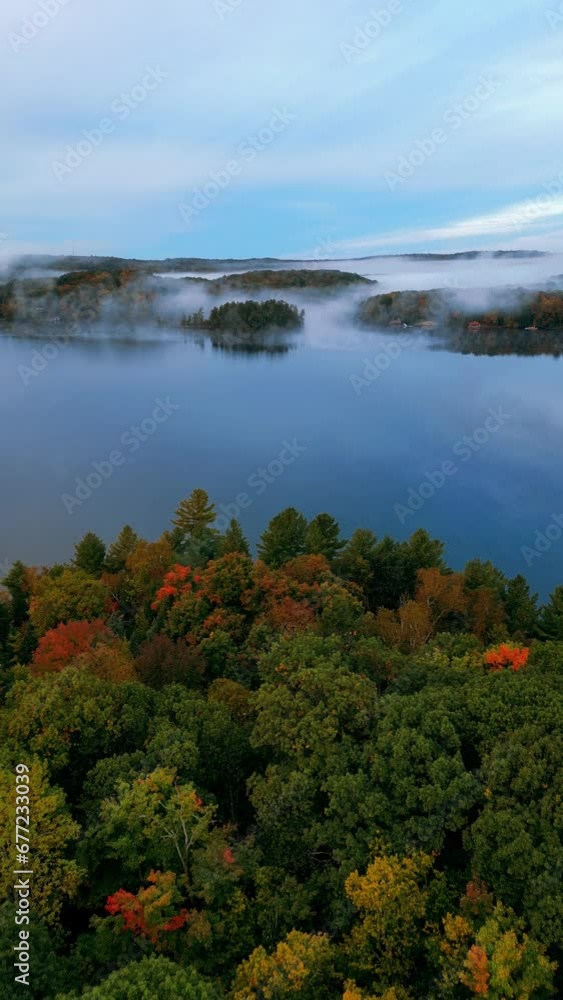 Drone view of a lake in a forest covered in the fog in Muskoka, Ontario, Canada Drone view of a lake in a forest covered in the fog in Muskoka, Ontario, Canada