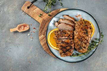 Duck breast with oranges and thyme on a light background top view. copy space