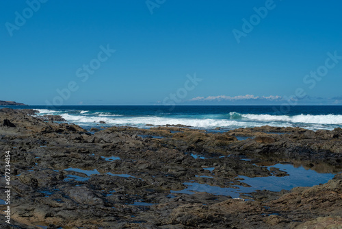 Beautiful landscape with deep blue water. Powerful waves crash against black volcanic rocks on the coast of   Aguas Verdes  Fuerteventura island. 