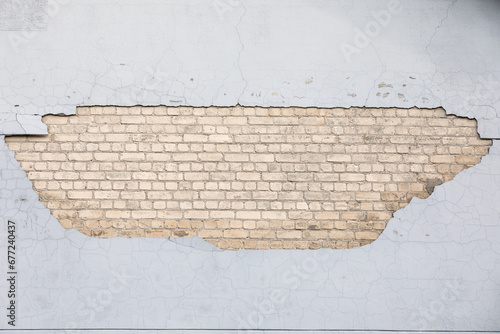 Plaster fell from the wall of the house. White bricks