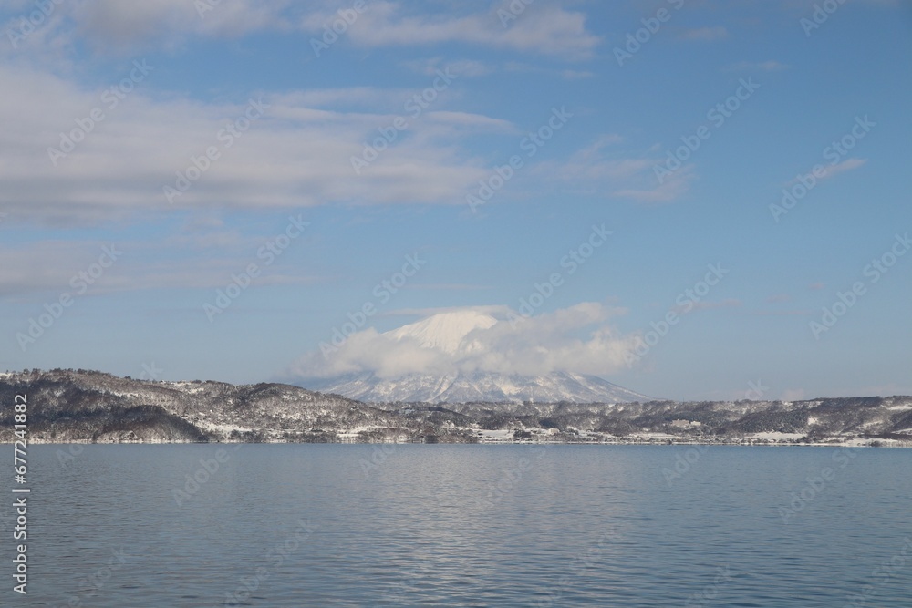 High-angle view of the lake and mountains covered by snow. High-angle view of the lake and mountains covered by snow.