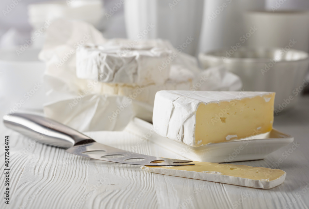 Camembert cheese on a white table.