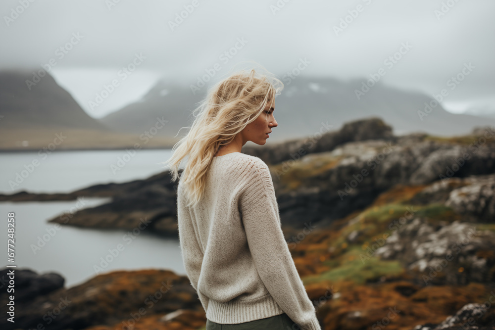 Overcast Serenity: Woman in Textured Knit Observes the Quietude of Oceanfront Rocks. Overcast Serenity: Woman in Textured Knit Observes the Quietude of Oceanfront Rocks.