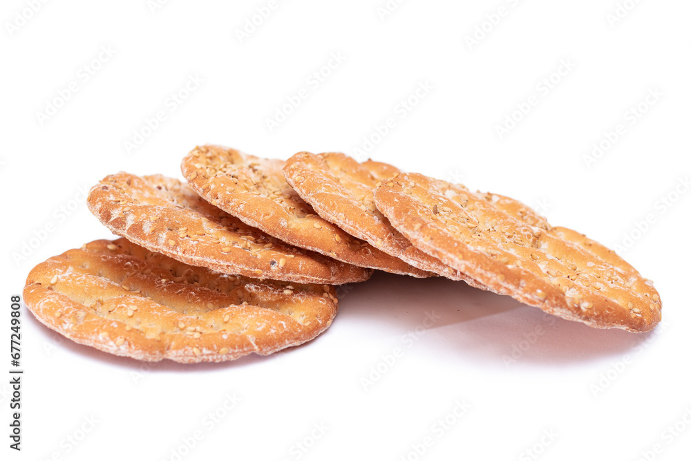 A Heap of Round Salt Crackers with Sesame Isolated on White Background. Dry Snacks - Isolation A Heap of Round Salt Crackers with Sesame Isolated on White Background. Dry Snacks - Isolation