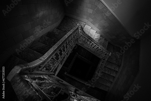 High angle of a spiral staircase in a building in Cienfuegos, Cuba shot in grayscale photo