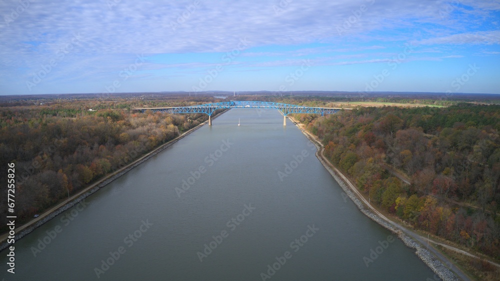 Aerial view of a river landscape surrounded by lush forests under a cloudy sky