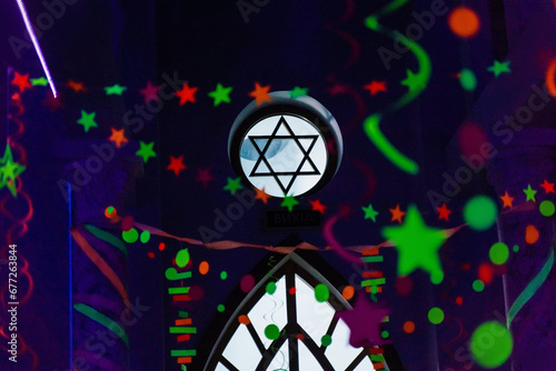 Ultraviolet decoration for celebration Purim Jewish holiday. Colored Purim festival decoration with David star in center. photo