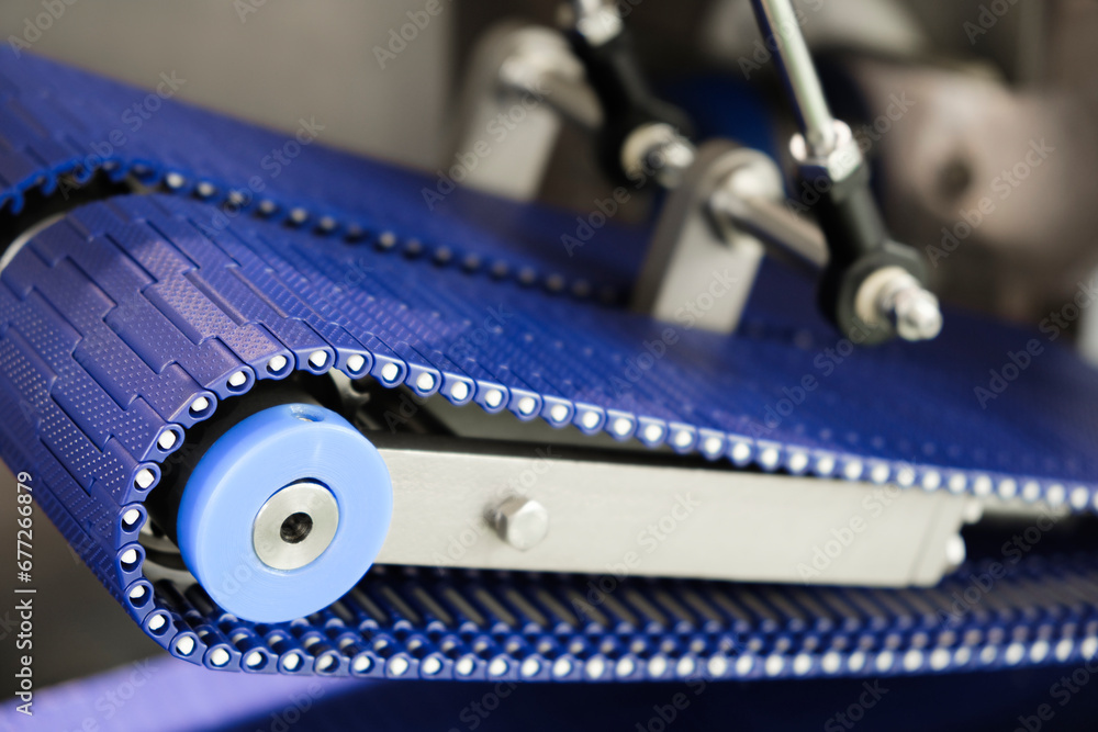 Gear chain drive shaft in conveyor belt is on production line. Timing