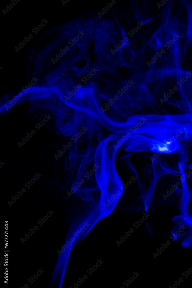 Fototapeta premium blue Smoke in cigarette in dark Background