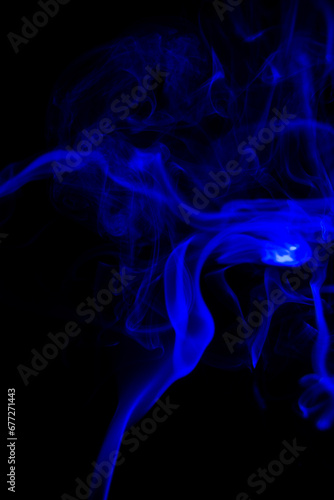 blue Smoke in cigarette in dark Background