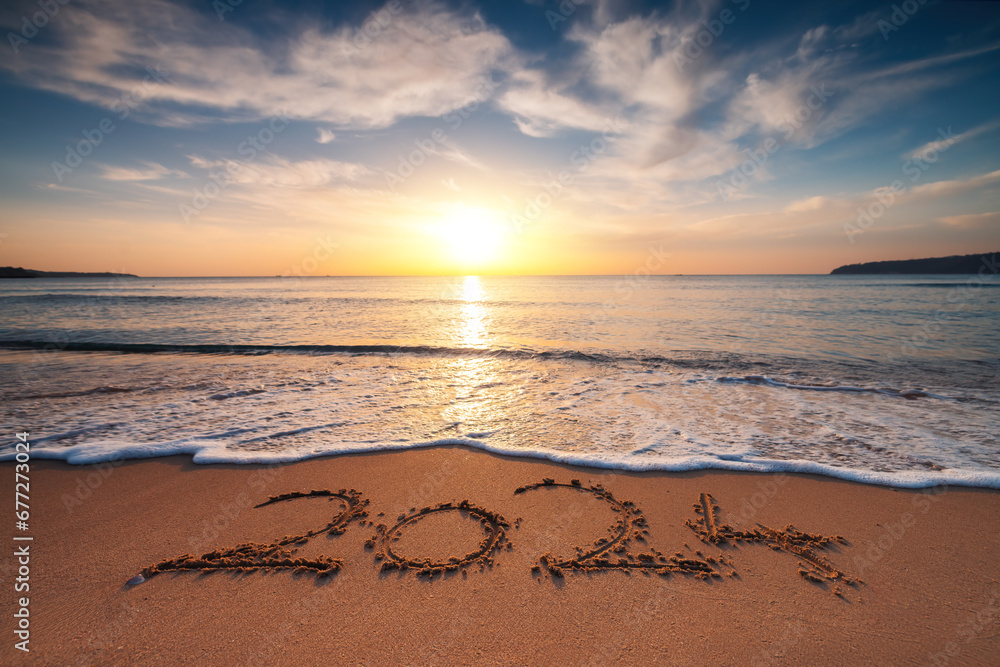 Happy New Year 2024 concept, lettering on the beach. Written text on the sea beach at sunrise. - obrazy, fototapety, plakaty 