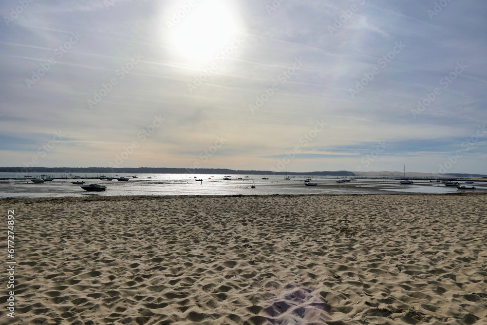 Obraz premium Evening on the shoreline at Cap Ferret looking across the Arcachon Bay towards the shoreline of Arcachon, France 