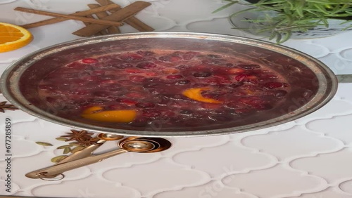 Woman hand cooking cranberry sauce .Fresh homemade cranberry sauce 