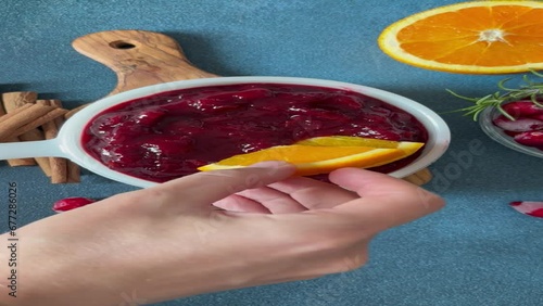 Woman hand cooking cranberry sauce .Fresh homemade cranberry sauce 