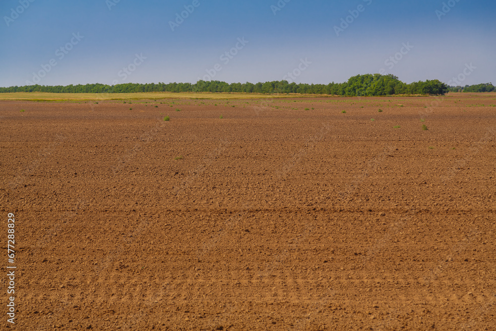 A plowed field prepared for planting crops. A plowed field prepared for planting crops.