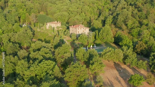 Pool villas in Tuscany in beautiful golden light. Crane like tilt drone shot photo