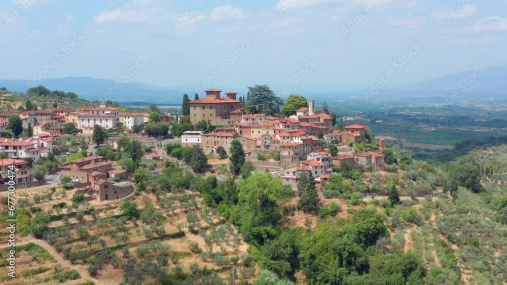 Village on hill in Tuscany Italy. Circling drone shot around old building church Village on hill in Tuscany Italy. Circling drone shot around old building church