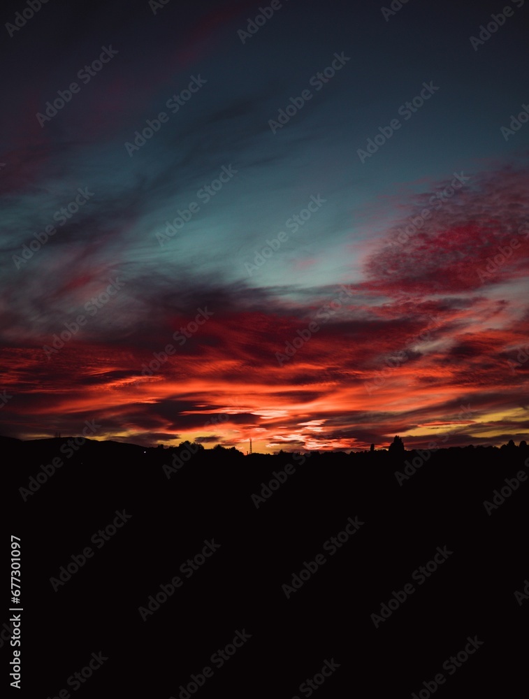 Beautiful vertical shot of a red sunset with cloudy sky in Sofia, Bulgaria