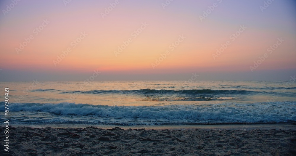 Beautiful amazing sunset over tropical ocean sea beach with pink purple sky and waves breaking on beach in summer Thailand, tourism vacation holiday travel trip destination concept