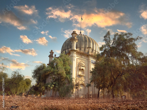 Behold the timeless allure of the Tomb of Bahawalpur. This image encapsulates the fusion of Islamic and Mughal architecture, narrating the cultural legacy of South Asia. With intricate carvings and ma (ID: 677301461)