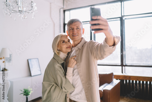 Happy senior couple taking selfie on smartphone