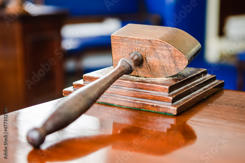 Wooden hammer sits on a table in a Craft Lodge room in a Masonic hall. photo