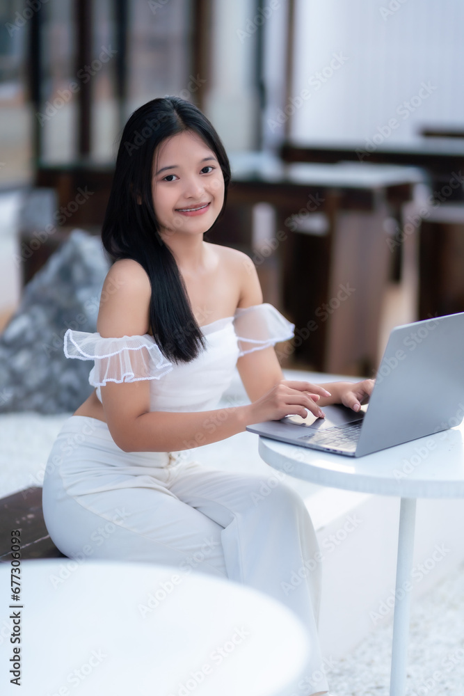 Portrait of asian freelance teenage people businesswoman casual working with laptop computer in cafe interior in coffee shop background,business expressed confidence embolden and successful concept Portrait of asian freelance teenage people businesswoman casual working with laptop computer in cafe interior in coffee shop background,business expressed confidence embolden and successful concept