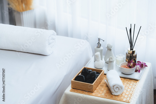 Exquisite display of beauty treatment and spa salon accessories arranged on spa table in luxury spa resort. Relaxing spa massage and recreation background concept. Quiescent photo