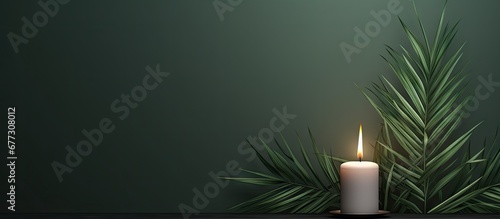 Catholic symbolism of Ash Wednesday Lent and Holy Week with cross palm leaf and candle Copy space image Place for adding text or design photo