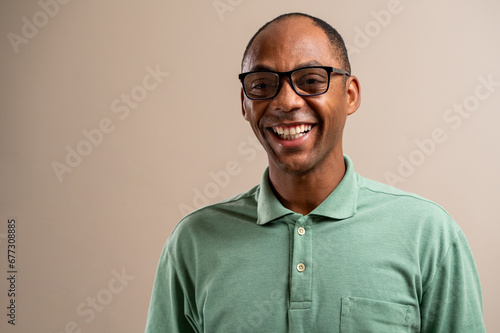 Man wearing glasses smiling on pastel background. photo