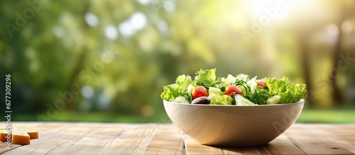 Caesar salad outdoors served on a white wooden table in the garden Copy space image Place for adding text or design