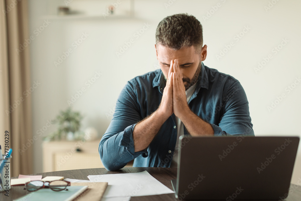 worried middle aged man at laptop suffering from stress indoor - obrazy, fototapety, plakaty 