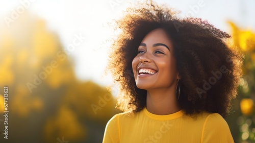 image of a happy black woman outside against a yellow backdrop photo